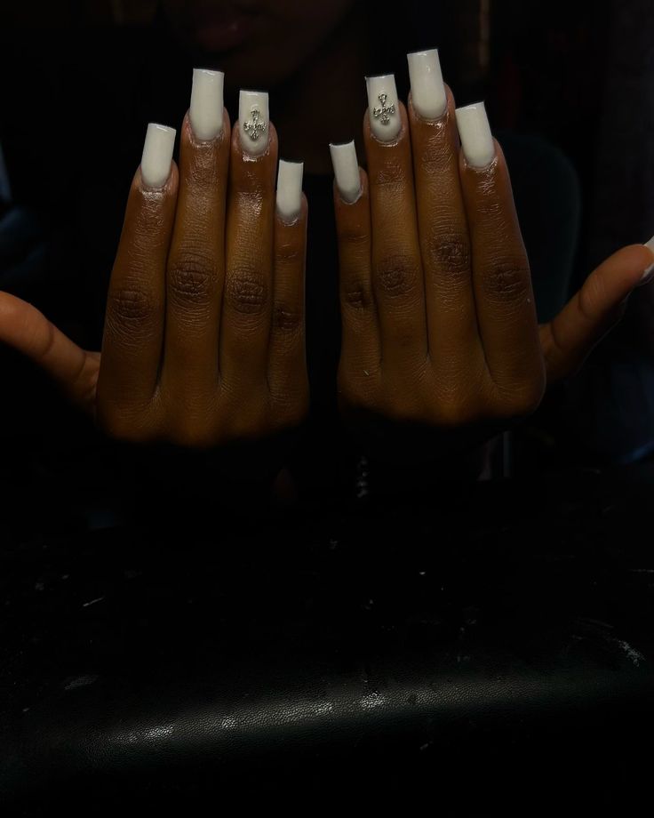 Glamorous White Acrylic Nails: Elegant Shimmering Designs with Versatile Long Shape.