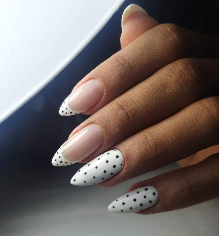 Chic Nail Design: Nude and White Polish with French Tips and Playful Polka Dots.