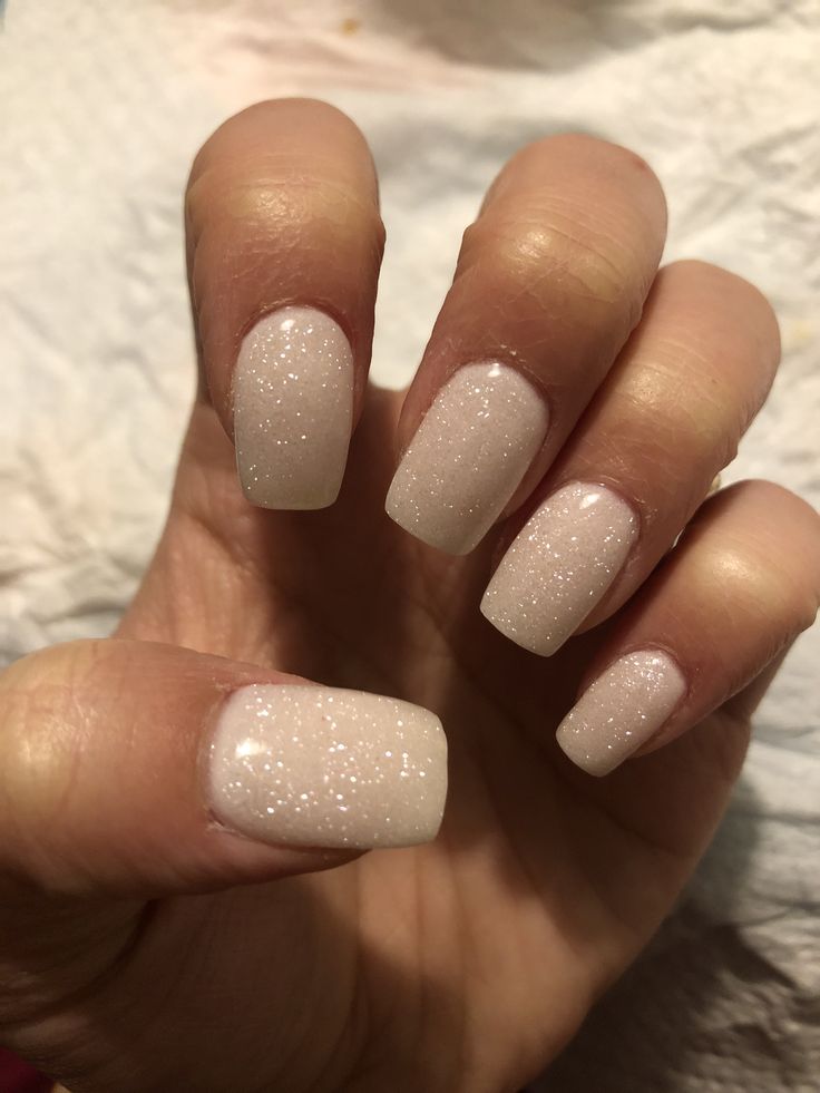 Elegant Shimmering Nail Design with Sheer White Base and Sparkling Texture.