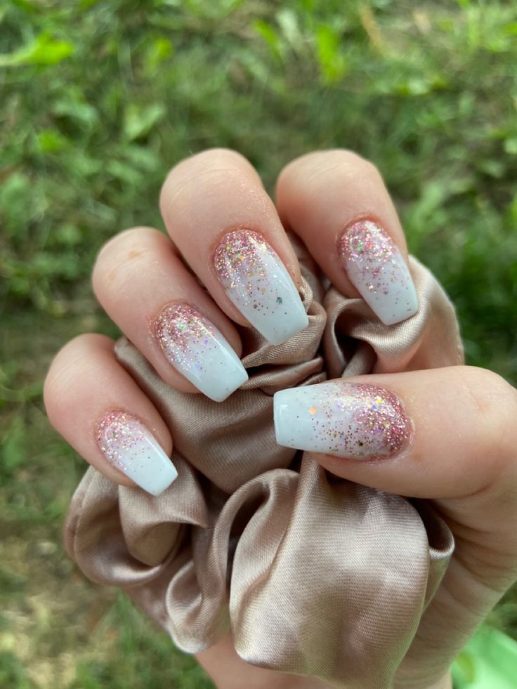 Sophisticated Gradient Rose Gold to White Nail Design with Glitter Accents.