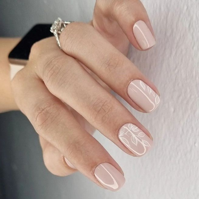 Elegant Pastel Pink Nail Design with Sophisticated White Floral Patterns.