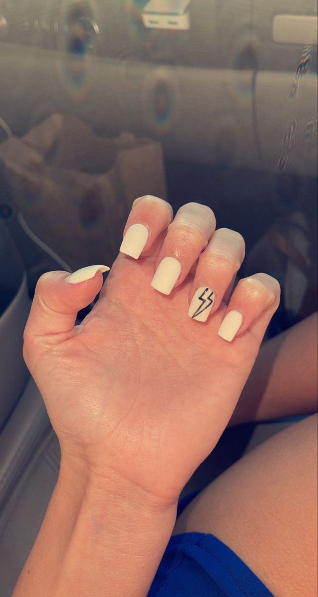 Modern Chic White Nail Design with Edgy Lightning Bolt Accent