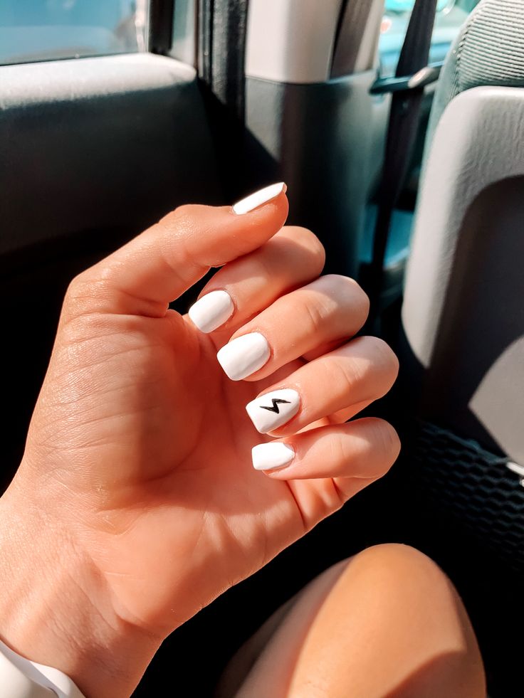 Sleek Minimalist White Nails with Bold Black Lightning Bolt Detail