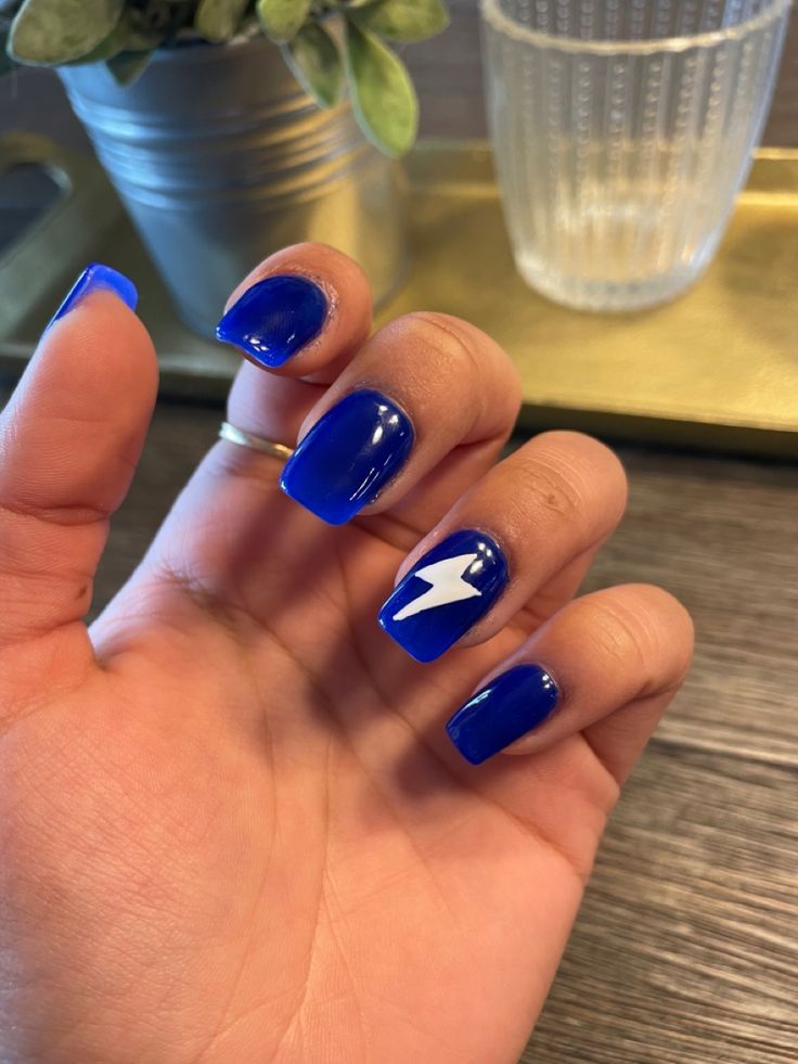 Bold Glossy Blue Nails with Unique Lightning Bolt Design for a Striking Statement Look.