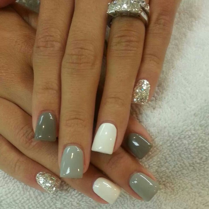 Sophisticated and Playful Gray and White Nail Design with Glitter Accents.