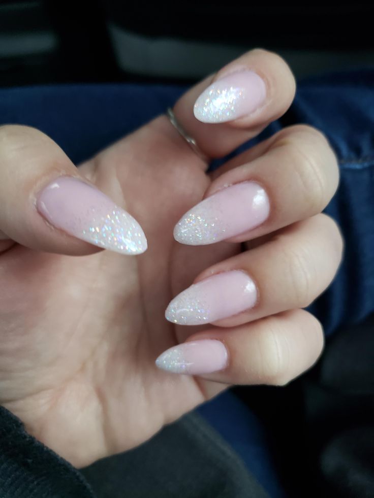 Glamorous Almond-Shaped Nails with Soft Pink Base and Sparkling Glitter Tips.