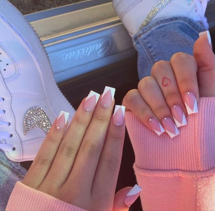 Stylish French Tip Nail Design with Pink Ombre and Shimmering Accents for a Trendy Look.