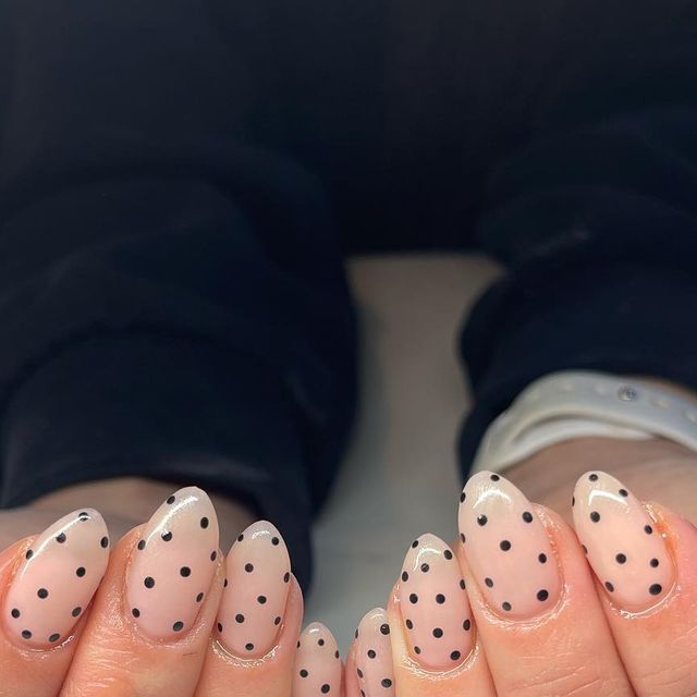 Chic Almond-Shaped Nails: Soft Nude with Playful Black Polka Dots