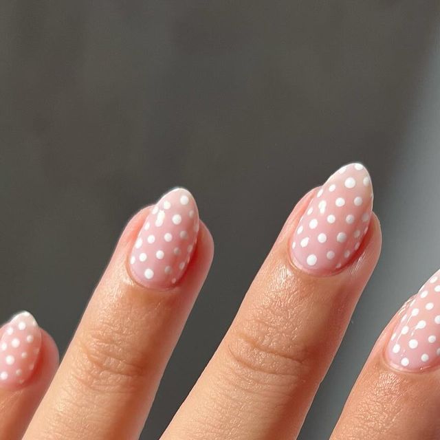 Charming Delicate Pink Nail Design with Playful White Polka Dots