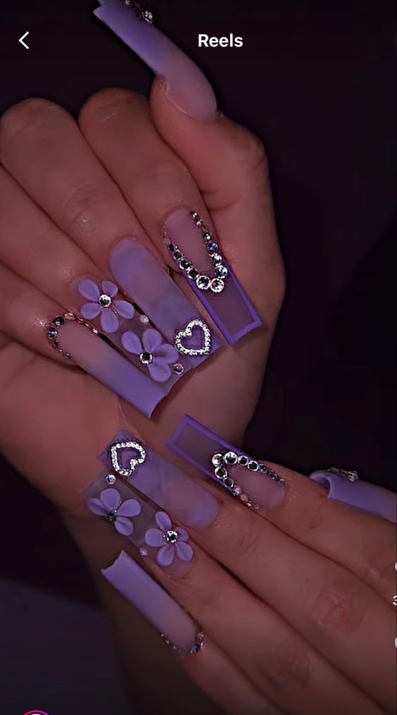 Elegant Lavender-Themed Nail Design with Intricate Details and Sparkling Embellishments.