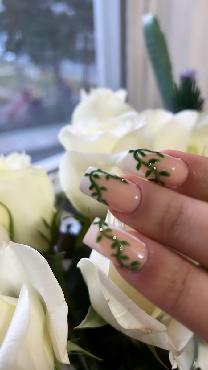 Elegant Nude Nail Design with Intricate Green Vines and Gem Accents for a Botanical Touch.