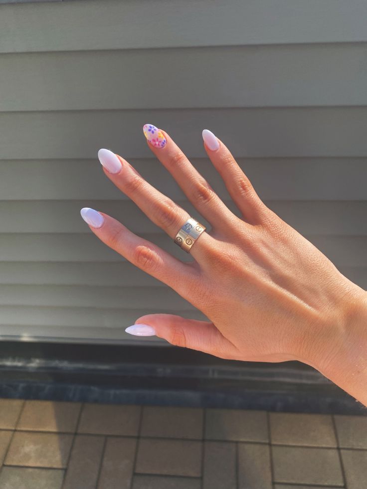 Chic Lavender Almond Nails with Delicate Floral Accent for a Fresh, Modern Look.