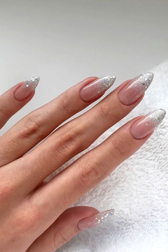 Chic Soft Pink Nails with Sparkling Silver Tips and Gradient Effect.