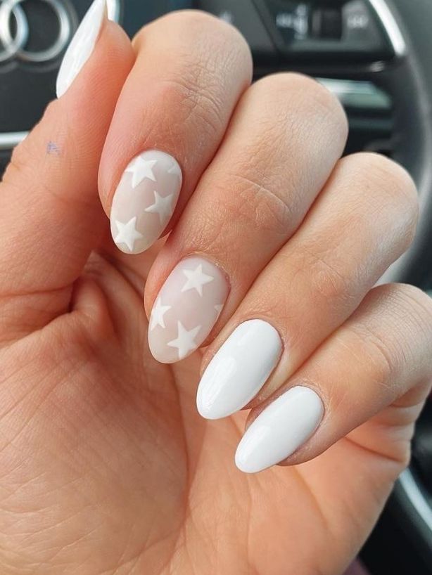 Sophisticated Nail Design: Solid White and Sheer Polish with Whimsical Star Accents.