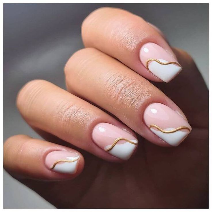 Chic Nail Design: Soft Pink Base with Classic White Tips and Elegant Golden Waves.