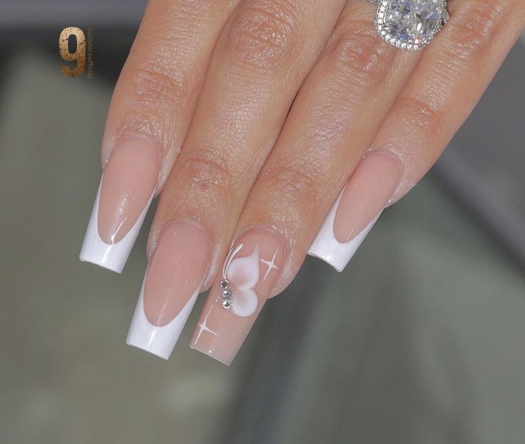 Sophisticated Long Nails: Nude Base, Classic French Tips, and Floral Delicacy with Sparkling Touches.