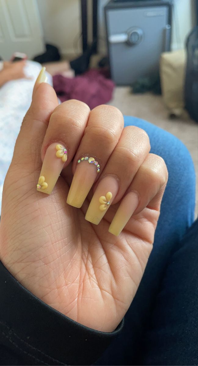 Chic Yellow Floral Nail Design with Rhinestone Accents for Spring/Summer.