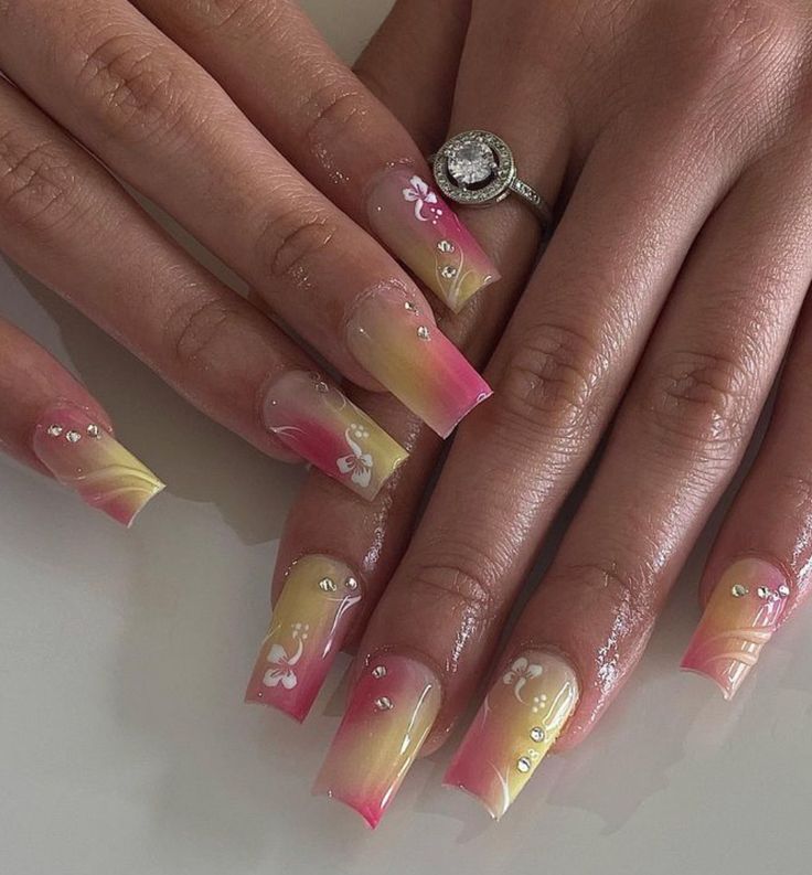 Vibrant Ombre Nail Design with Yellow-Pink Blend and Floral Accents