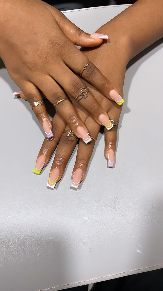 Stylish Manicure: Elegant Nude and Pastel Tips for Playful Sophistication.