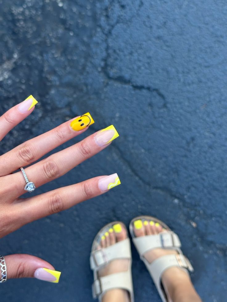 Bright and Playful Yellow Smiley Nail Design with Matching Pedicure for a Cheerful Summer Vibe.