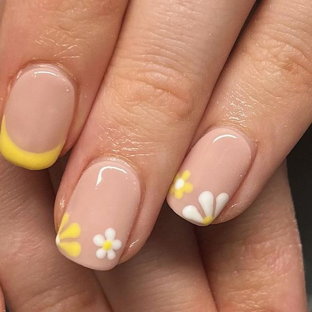 Cheerful Floral Nail Design with Soft Nude Base and Vibrant Yellow Accents