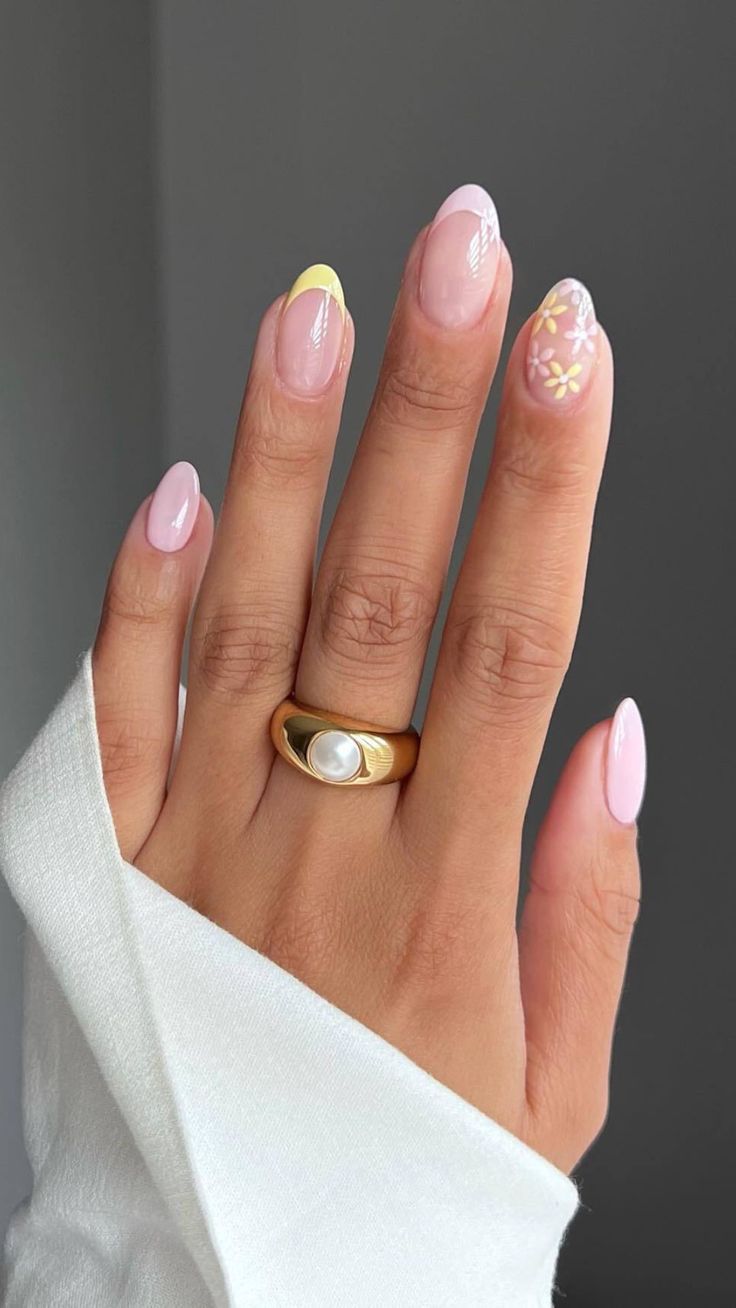 Chic Modern Nail Art: Soft Pink Base with Playful Yellow Tip and Floral Accents