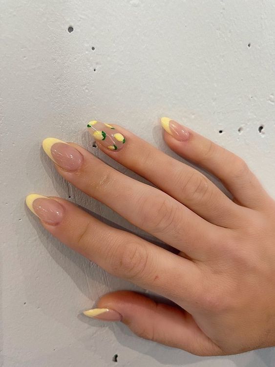 Cheerful Pastel Nail Design with Yellow Tips and Playful Green Accents