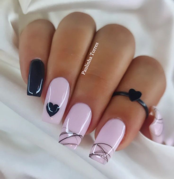 Elegant Chic Nail Design: Soft Pinks and Sleek Black with Heart Accents and Minimalist Wire Detailing.