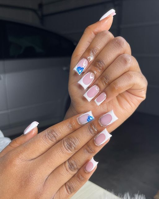 Elegant Nail Design with Soft Pink, White, and Playful Blue Heart Accent