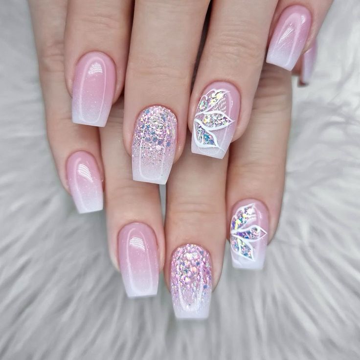 Elegant Ombre Nail Design with Soft Pink Gradient and Sparkling Floral Accents.