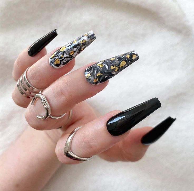 Elegant Edgy Nail Design: Bold Black with Gold-Accented Marble Pattern