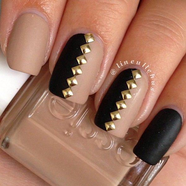 Chic Nail Design: Matte Black and Nude with Gold Accents for Modern Elegance.