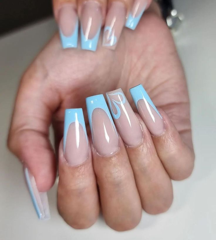 Chic Nail Design: Soft Nude Meets Vibrant Blue in Creative Patterns