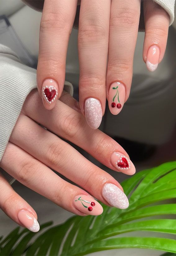 Charming Peach Nail Design with Pearl Accents, Playful Cherry Illustrations, and Sparkling Red Hearts.