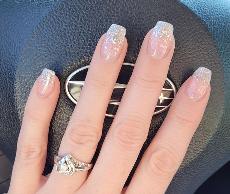 Elegant Glitter Ombre Nails: Soft Pink to Shimmering Clear Tips.