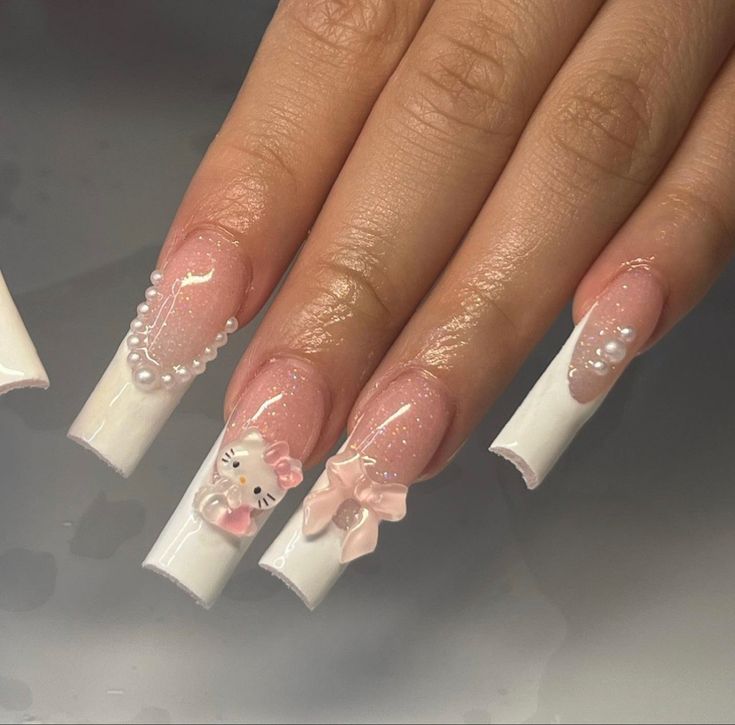 Whimsical Feminine Nail Design with Glossy White Tips, Soft Pink Accents, and Pearl Embellishments.