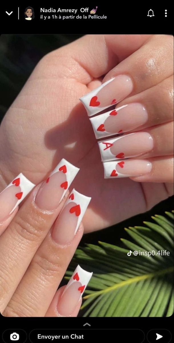 Charming Heart Motif Nail Design with Abstract White Tips and Vibrant Red Accents