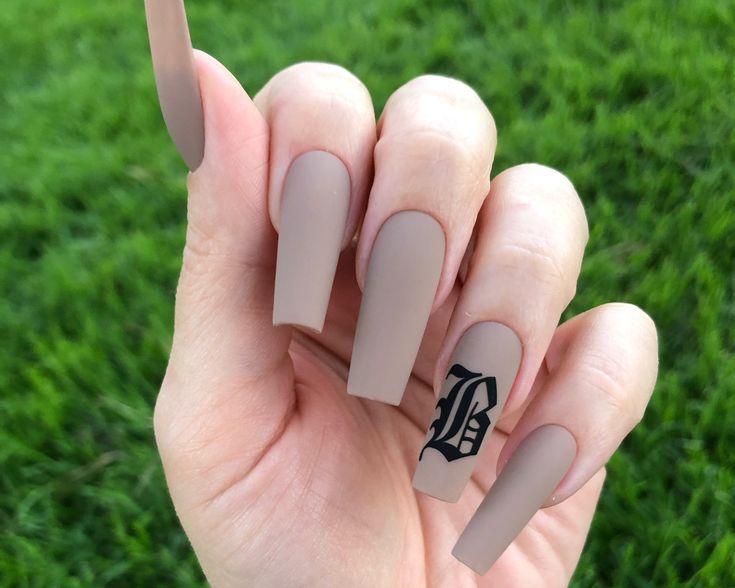 Chic Matte Nude Nails with Bold Black Accent for a Sophisticated Look.