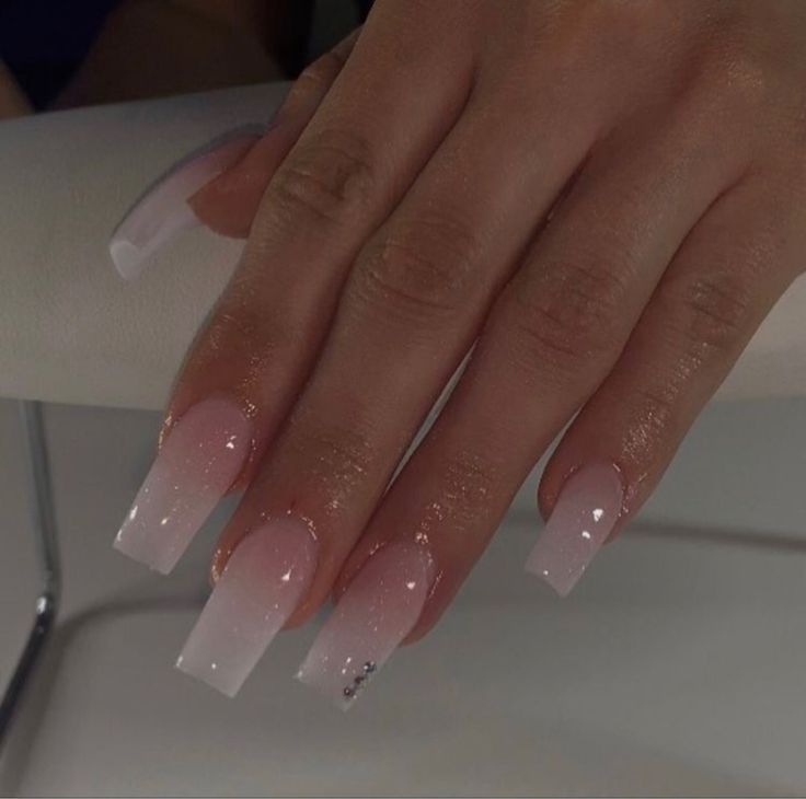 Elegant Ombre Nail Design with Soft Pink to White Gradient and Sparkling Accents.