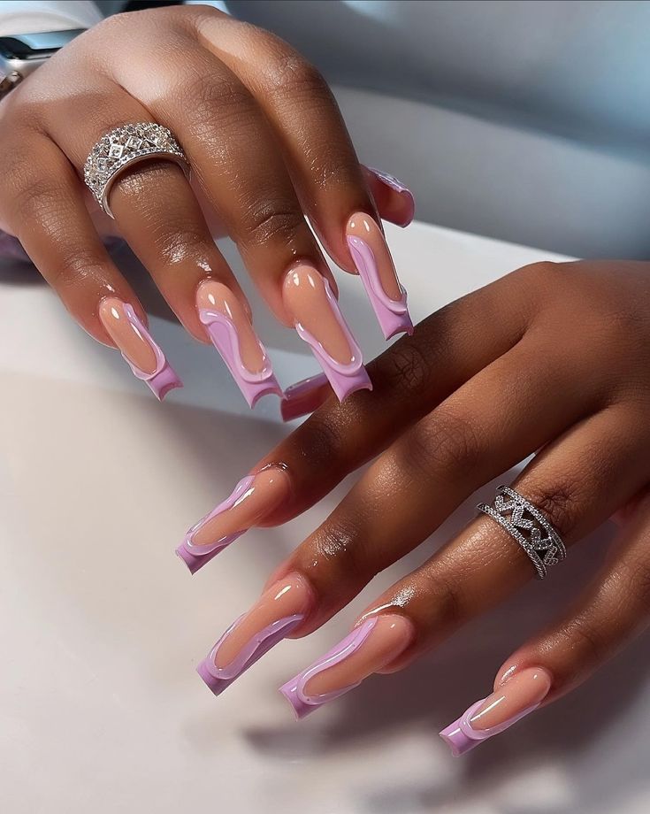 Chic Ombre Nail Design: Nude and Soft Pink Elegance with Glossy Coffin Shape and Delicate Rings.