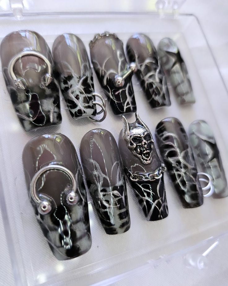 Gothic Edgy Nail Collection: Dark Elegance with Intricate Web Patterns and Metallic Accents.