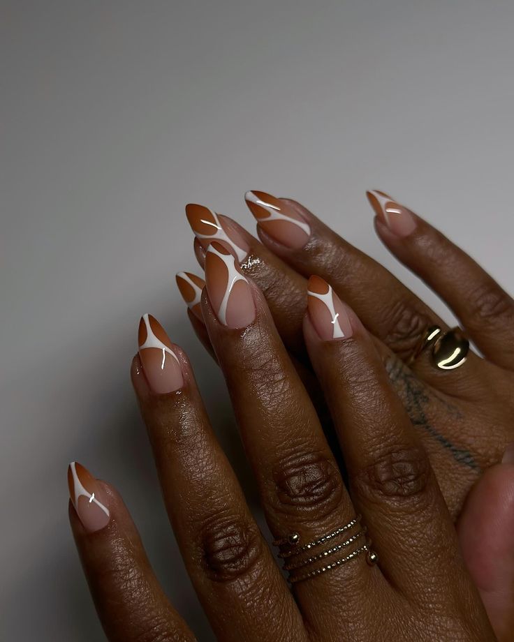 Chic geometric nail design in warm tones of beige and brown with elegant white accents.