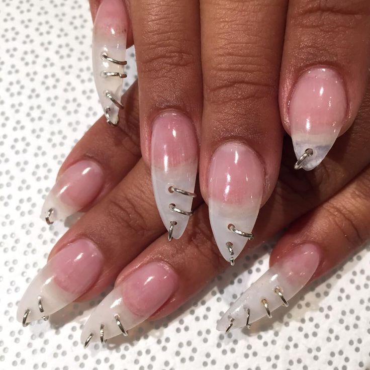 Sophisticated Ombre Nail Design: Soft Pink to Clear White with Metallic Silver Embellishments