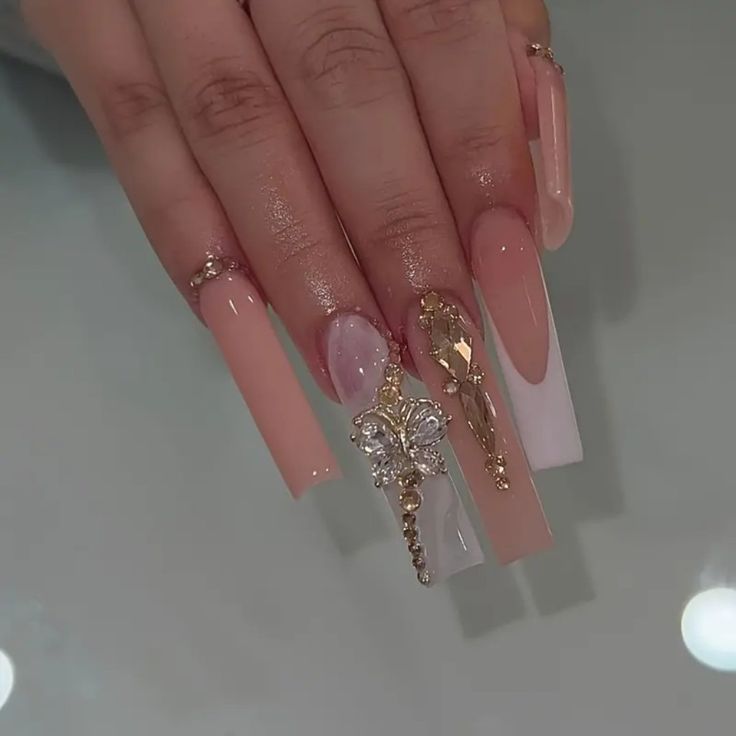 Luxurious Long Nail Design with Soft Pinks, Gold Charms, and Floral Motifs