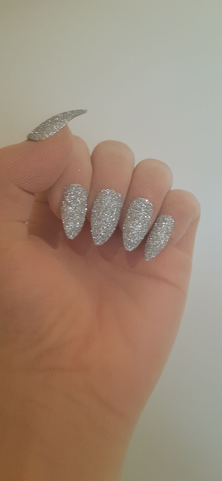 Glamorous Glittery Silver Stiletto Nails: Perfect for Festive Occasions and Everyday Sparkle.