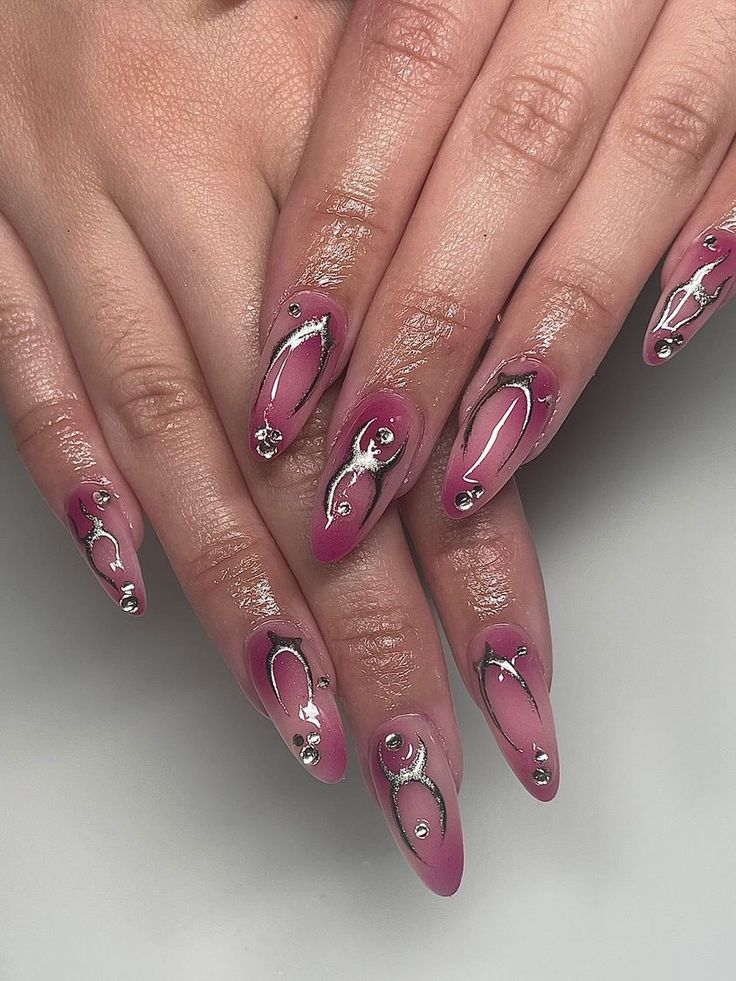 Elegant Pink Gradient Nail Design with Silver Accents and Rhinestones.