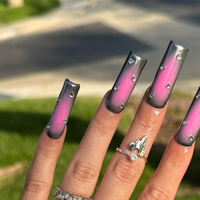 Bold Pink-to-Gray Gradient Nail Design with Sparkling Studs for a Modern Look.