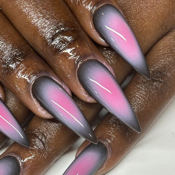 Elegant Ombre Stiletto Nails: Deep Pink to Charcoal Gray Gradient with Glossy Finish.