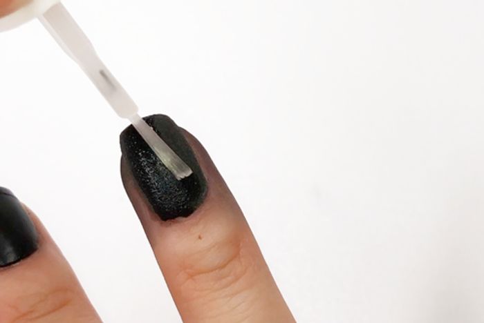 Striking Textured Black Nail Design with Glossy Top Coat for a Sophisticated Finish.