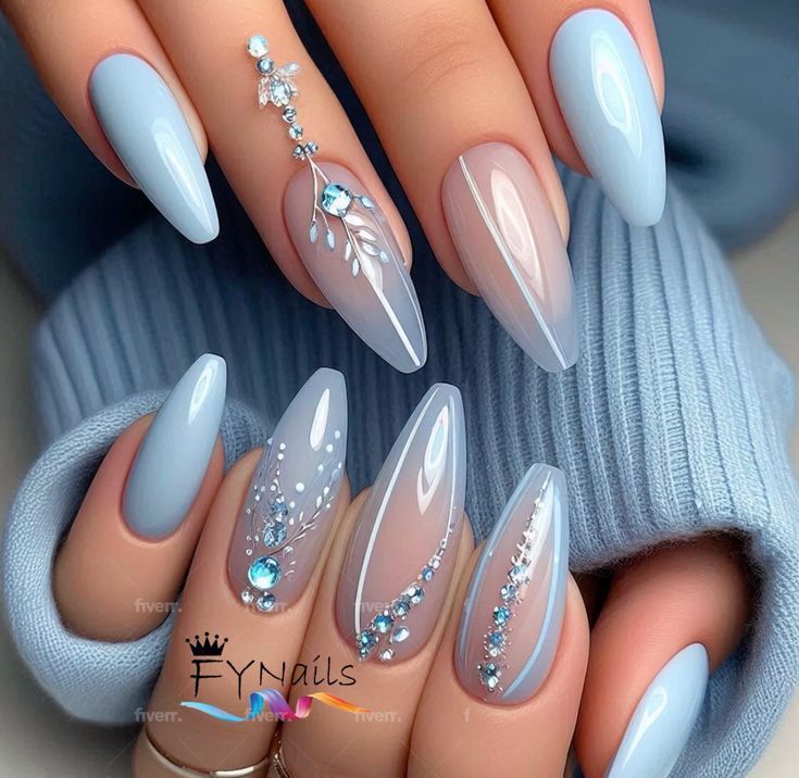 Elegant Soft Icy Blue Nails: A Serene and Fashionable Choice with Intricate Designs and Mixed Finishes.